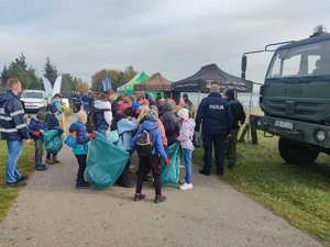 Umundurowani policjanci wraz z uczestnikami akcji sprzątania zbiornika wodnego Pogoria 4