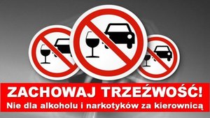 Napis &quot;Zachowaj trzeźwość! Nie dla alkoholu i narkotyków za kierownicą&quot;, nad nim w znaku zakazu przekreślony na czerwono samochód koloru czarnego i kieliszek.