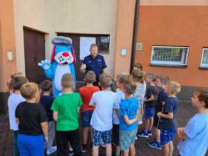 Umundurowany policjant i maskotka Sznupek na spotkaniach edukacyjnych w szkołach i przedszkolach.