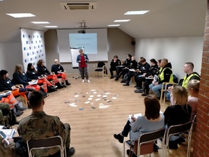 Nieumundurowani policjanci i kadeci z klas mundurowych na warsztatach i podczas zwiedzania obozu Auschwitz.