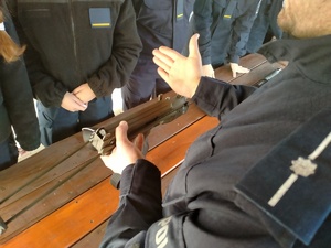 Umundurowany policjant omawia działanie jednostek broni palnej.
