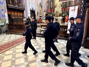 Umundurowani policjanci oraz kadeci ze szkoły mundurowej podczas uroczystej mszy świętej w kościele.