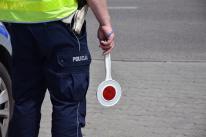 Umundurowany policjant z &quot;lizakiem &quot;policyjnym do zatrzymywania pojazdów