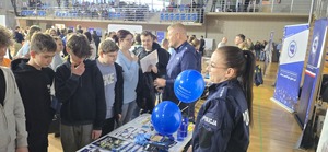Policjanci stojący przy stoisku prowadzą rozmowy z odwiedzającymi
