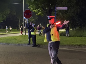 Zdjęcie przedstawia funkcjonariusza kierującego ruchem podczas zabezpieczenia I Maratonu Zagłębiowskiego w dniu 23 maja 2026 roku.